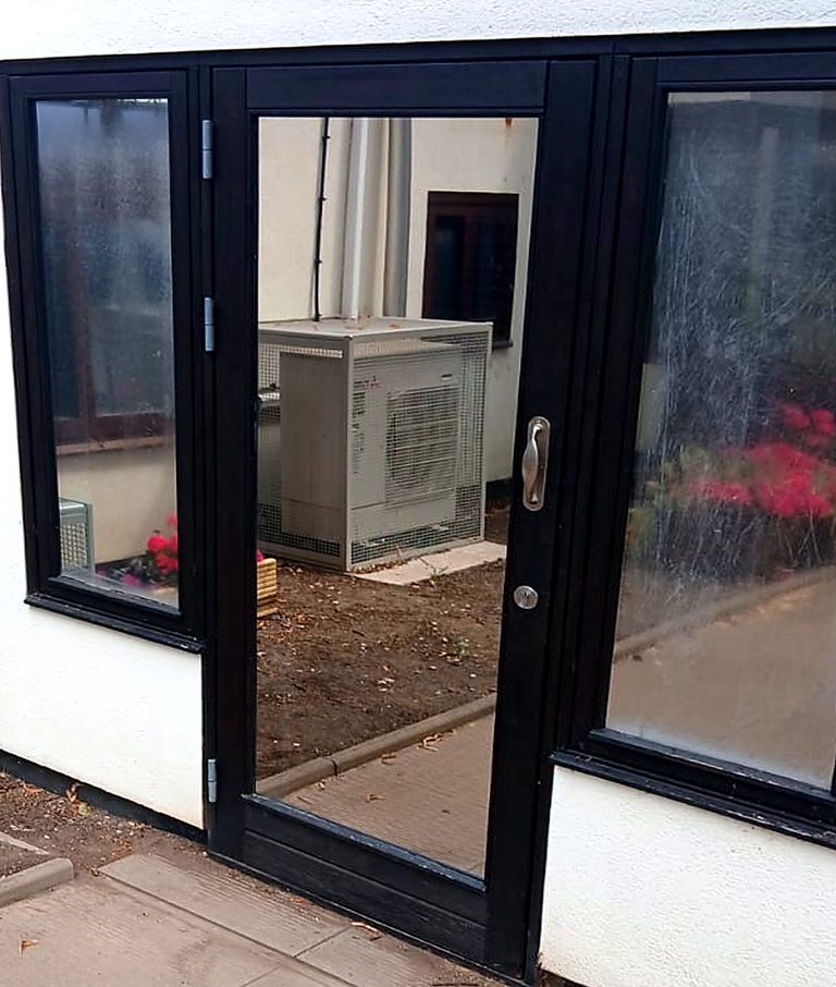 The same door after the sealed units were replaced, the glass clear enough to see the courtyard beyond