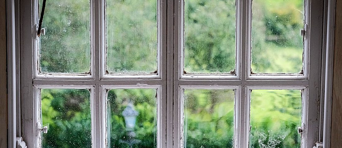 An old timber window with flaking paint