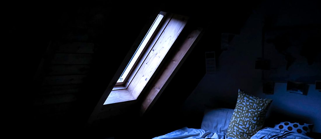 A roof window set into the sloping ceiling of a loft room